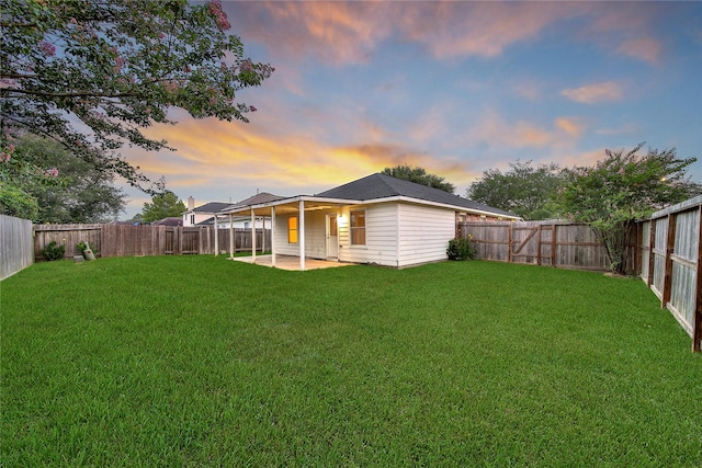 11703 Elizabeth Ct, Pinehurst, TX 77362 - back of property at dusk featuring a patio area and a fenced backyard
