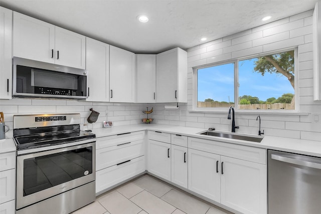 19702 Franz Rd, Houston, TX 77084 - kitchen featuring stainless steel appliances, light countertops, tasteful backsplash, light tile patterned floors, and recessed lighting