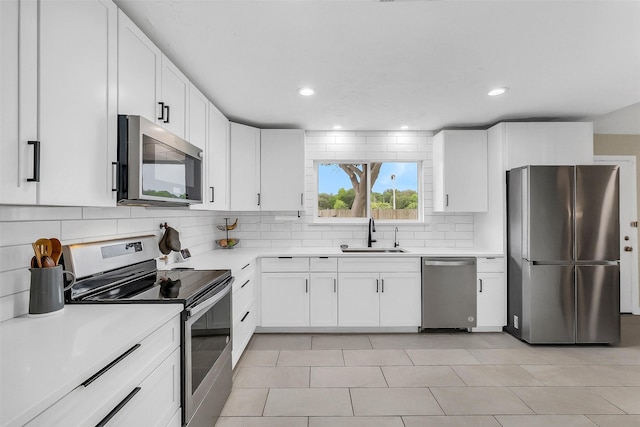 19702 Franz Rd, Houston, TX 77084 - kitchen with appliances with stainless steel finishes, backsplash, light countertops, white cabinetry, and recessed lighting