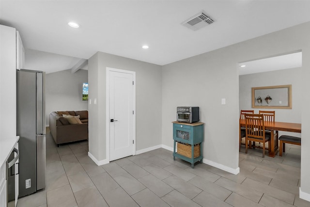 19702 Franz Rd, Houston, TX 77084 - kitchen featuring freestanding refrigerator, white cabinets, recessed lighting, light tile patterned flooring, and light countertops