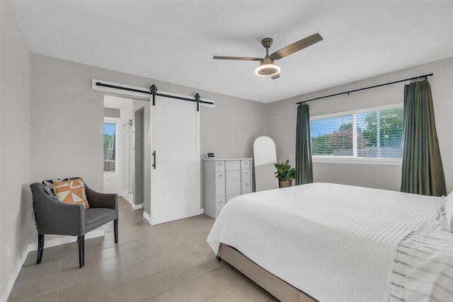19702 Franz Rd, Houston, TX 77084 - bedroom with a barn door, a ceiling fan, and light tile patterned floors