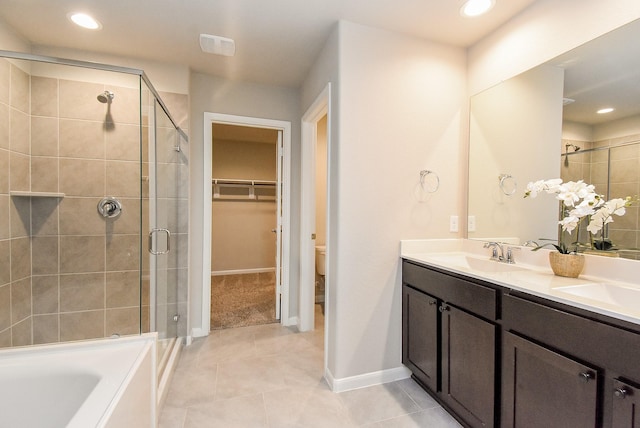 5602 Cedar Crescent Ct, Richmond, TX 77407 - bathroom with a shower stall, double vanity, tile patterned floors, a walk in closet, and recessed lighting