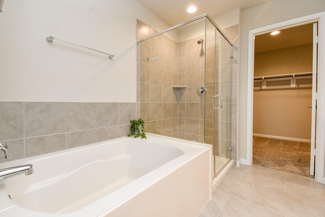 5602 Cedar Crescent Ct, Richmond, TX 77407 - bathroom with a bath, a stall shower, a walk in closet, recessed lighting, and tile patterned floors