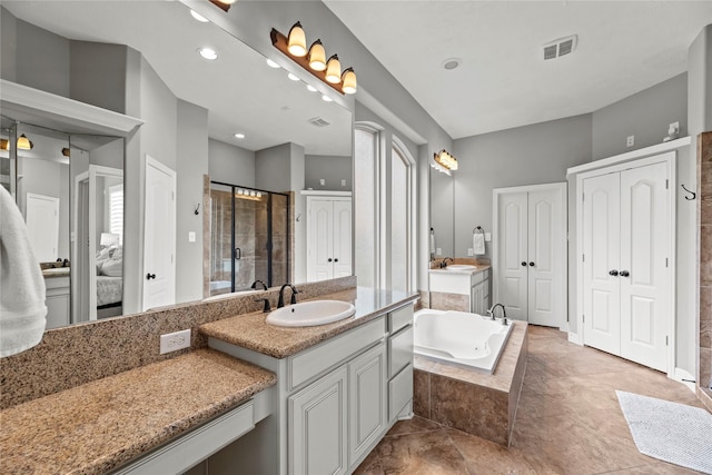 27410 Villa Mountain Ct, Fulshear, TX 77441 - bathroom featuring two vanities, a stall shower, a garden tub, and a closet