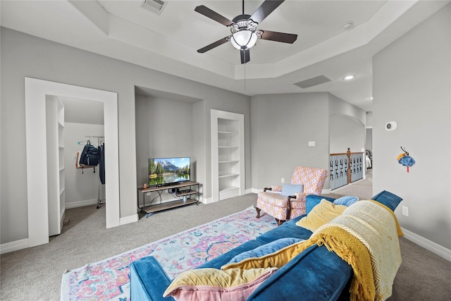 27410 Villa Mountain Ct, Fulshear, TX 77441 - carpeted living room featuring ceiling fan, a raised ceiling, and built in features