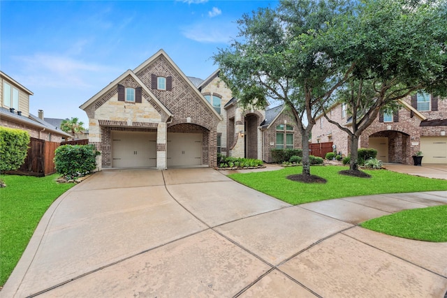 27410 Villa Mountain Ct, Fulshear, TX 77441 - french country style house with concrete driveway, brick siding, a garage, and stone siding