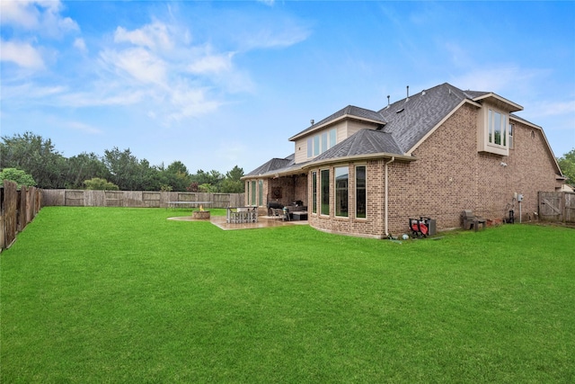 27410 Villa Mountain Ct, Fulshear, TX 77441 - back of property featuring a fenced backyard, brick siding, a patio, and a shingled roof