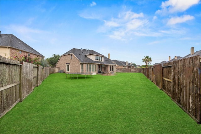 27410 Villa Mountain Ct, Fulshear, TX 77441 - fenced backyard with a trampoline