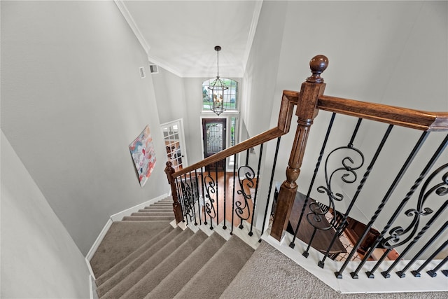 27410 Villa Mountain Ct, Fulshear, TX 77441 - stairway with carpet, ornamental molding, a chandelier, and a towering ceiling