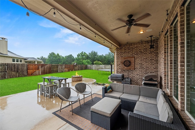 27410 Villa Mountain Ct, Fulshear, TX 77441 - fenced backyard featuring an outdoor living space with a fire pit, a patio, a ceiling fan, and a grill
