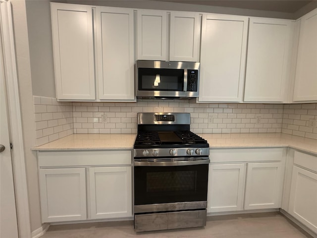8116 Tourmaline Way, Texas City, TX 77591 - kitchen with stainless steel appliances, white cabinetry, and backsplash