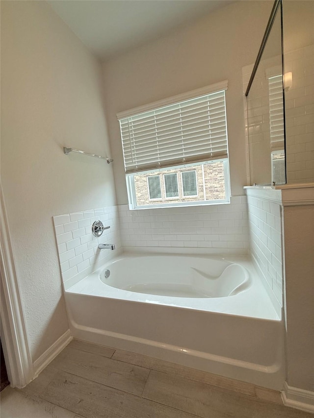8116 Tourmaline Way, Texas City, TX 77591 - full bath featuring a bath, healthy amount of natural light, and wood finished floors