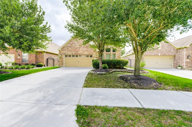 4927 Caponi Falls Ln, Katy, TX 77494 - obstructed view of property with driveway, brick siding, and an attached garage