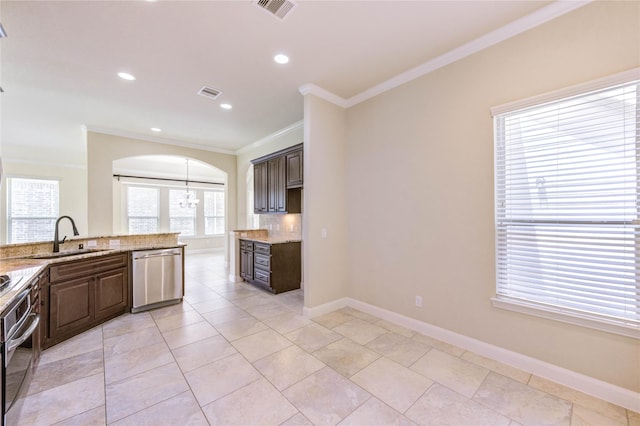 4927 Caponi Falls Ln, Katy, TX 77494 - kitchen with stainless steel appliances, ornamental molding, decorative backsplash, dark brown cabinets, and light stone counters