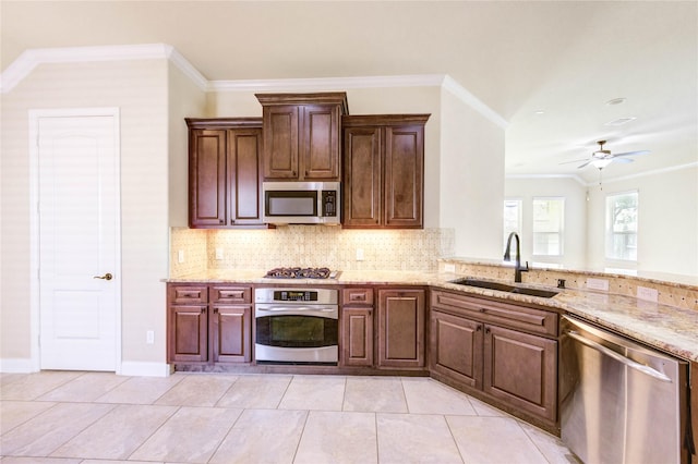 4927 Caponi Falls Ln, Katy, TX 77494 - kitchen with appliances with stainless steel finishes, ornamental molding, backsplash, light stone countertops, and ceiling fan