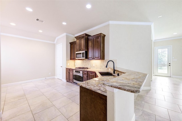 4927 Caponi Falls Ln, Katy, TX 77494 - kitchen featuring stainless steel appliances, light stone countertops, decorative backsplash, a peninsula, and crown molding