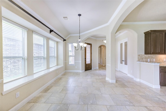 4927 Caponi Falls Ln, Katy, TX 77494 - unfurnished dining area with a chandelier, crown molding, arched walkways, french doors, and lofted ceiling
