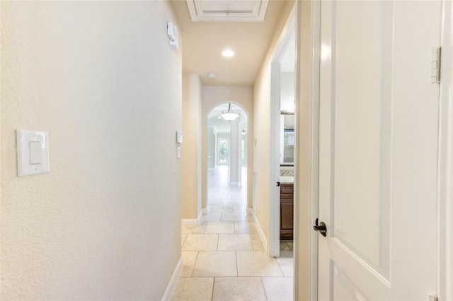 4927 Caponi Falls Ln, Katy, TX 77494 - hallway with arched walkways, attic access, and light tile patterned floors