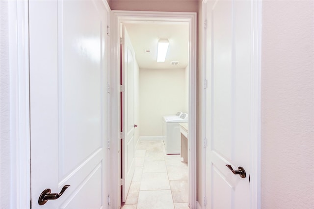4927 Caponi Falls Ln, Katy, TX 77494 - hallway with independent washer and dryer and light tile patterned floors