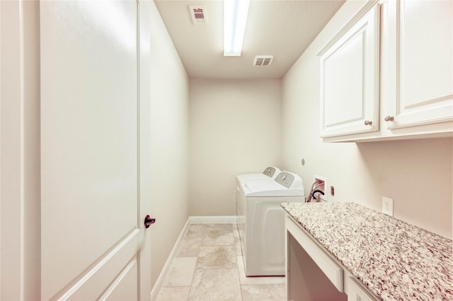 4927 Caponi Falls Ln, Katy, TX 77494 - laundry room with washer and dryer, cabinet space, and light tile patterned floors