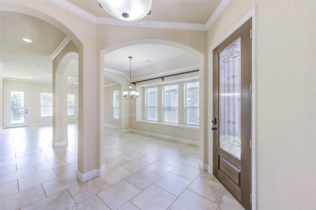 4927 Caponi Falls Ln, Katy, TX 77494 - entrance foyer with plenty of natural light, ornamental molding, a chandelier, and arched walkways