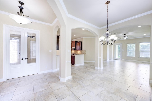 4927 Caponi Falls Ln, Katy, TX 77494 - foyer with ornamental molding, ceiling fan, french doors, arched walkways, and recessed lighting