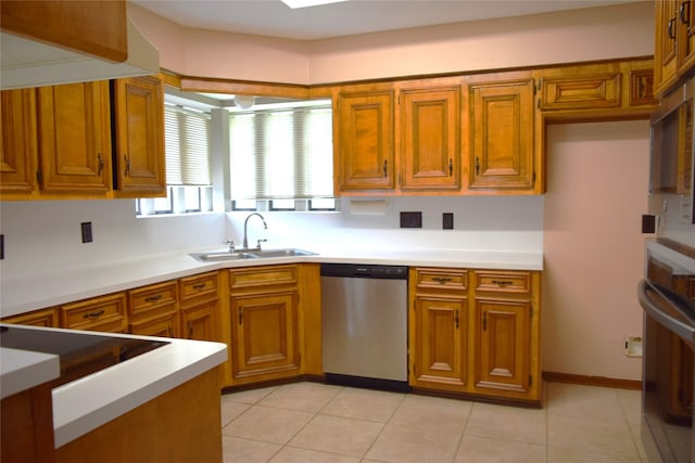 7331 Rancho Mission Dr, Houston, TX 77083 - kitchen with stainless steel appliances, brown cabinets, light countertops, and light tile patterned floors