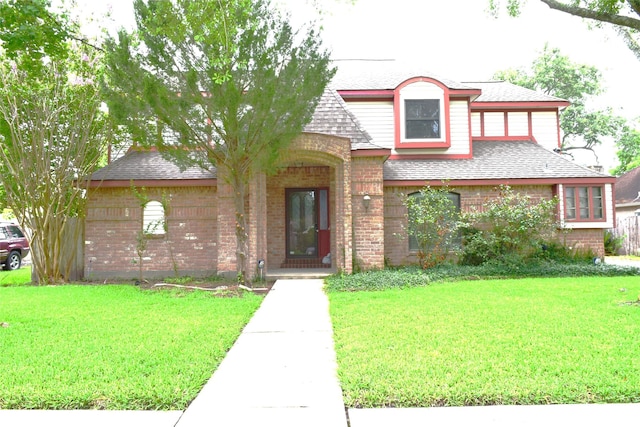 7331 Rancho Mission Dr, Houston, TX 77083 - view of front of house featuring brick siding, roof with shingles, and a front yard