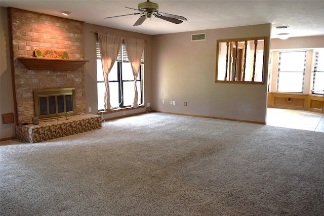 7331 Rancho Mission Dr, Houston, TX 77083 - unfurnished living room with carpet, ceiling fan, plenty of natural light, and a brick fireplace