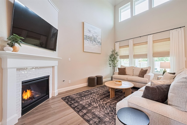 21031 Secretariat Meadow Ln, Tomball, TX 77377 - living area with a fireplace, wood finished floors, and a towering ceiling