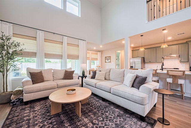 21031 Secretariat Meadow Ln, Tomball, TX 77377 - living area with light wood-style floors and a towering ceiling