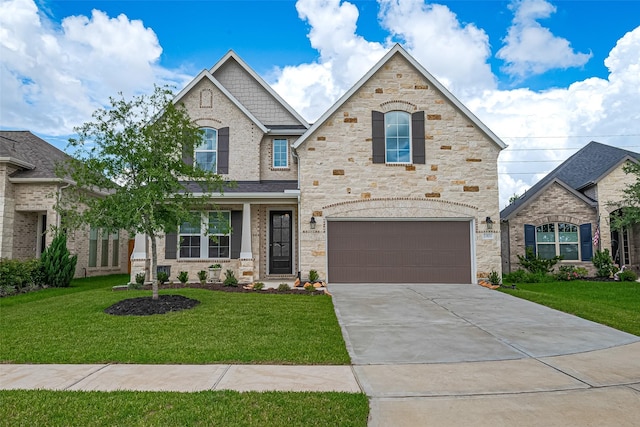 21031 Secretariat Meadow Ln, Tomball, TX 77377 - view of front of home featuring a garage, driveway, a front lawn, and stone siding