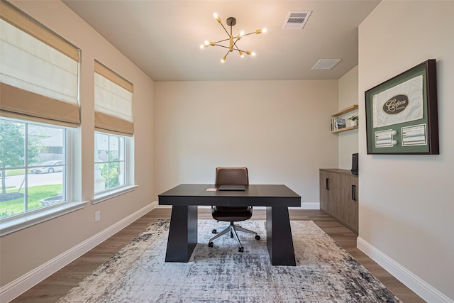 21031 Secretariat Meadow Ln, Tomball, TX 77377 - home office with dark wood-style flooring and a chandelier
