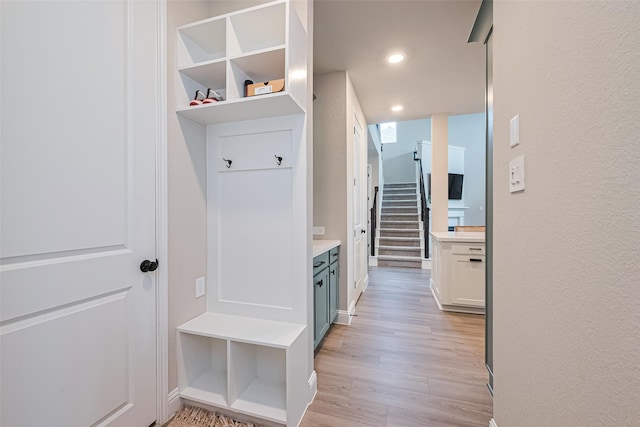 21031 Secretariat Meadow Ln, Tomball, TX 77377 - mudroom with light wood-type flooring, recessed lighting, and a textured wall