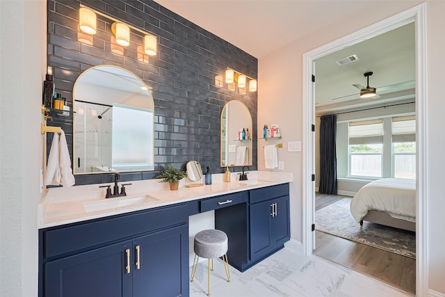 21031 Secretariat Meadow Ln, Tomball, TX 77377 - full bath with ceiling fan, double vanity, a shower with shower door, marble look tiles, and connected bathroom