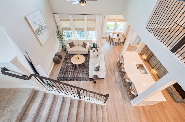 21031 Secretariat Meadow Ln, Tomball, TX 77377 - living room featuring wood finished floors, ceiling fan, and stairs