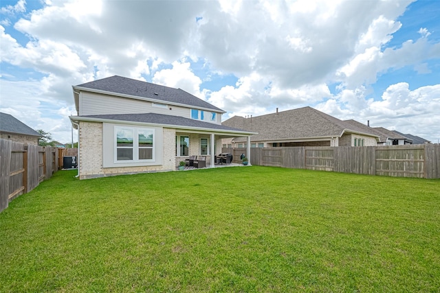 21031 Secretariat Meadow Ln, Tomball, TX 77377 - back of house with a fenced backyard, a patio area, and brick siding