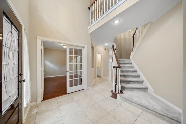 5411 Davids Bend Dr, Sugar Land, TX 77479 - entrance foyer with french doors, stairs, tile patterned flooring, a high ceiling, and crown molding