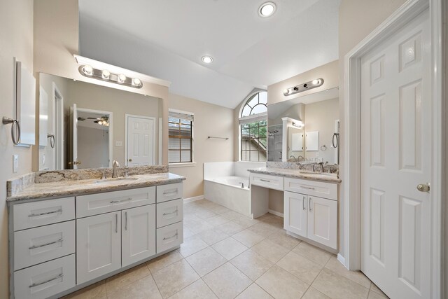 5411 Davids Bend Dr, Sugar Land, TX 77479 - bathroom featuring vaulted ceiling, two vanities, a bath, tile patterned floors, and ceiling fan