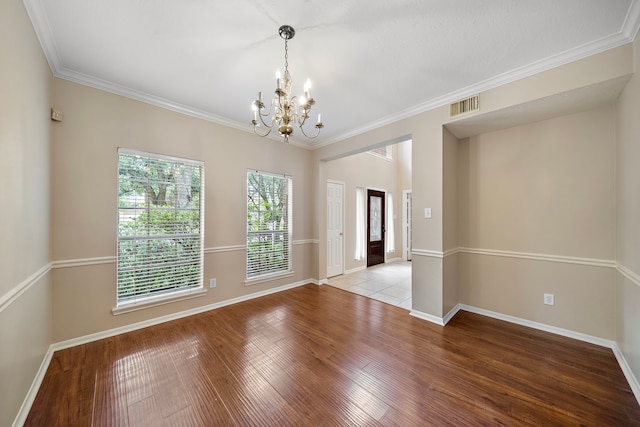 5411 Davids Bend Dr, Sugar Land, TX 77479 - spare room featuring a chandelier, light wood-style floors, and crown molding