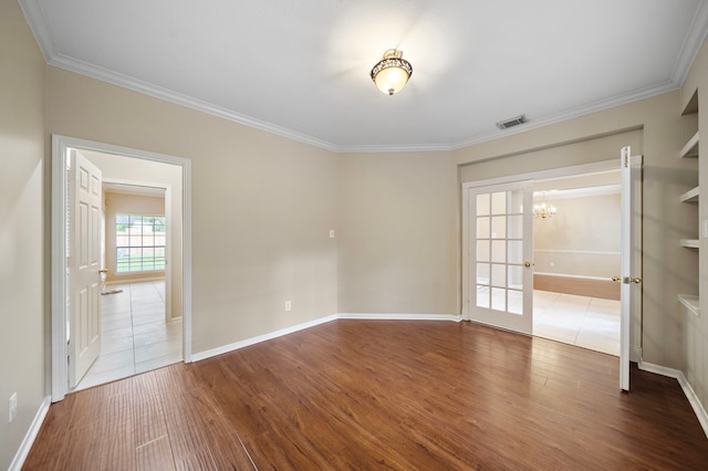5411 Davids Bend Dr, Sugar Land, TX 77479 - unfurnished room featuring a chandelier, wood finished floors, and crown molding