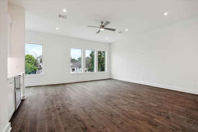 1609 Roy St, Houston, TX 77007 - unfurnished living room with healthy amount of natural light, dark wood finished floors, a ceiling fan, recessed lighting, and wine cooler