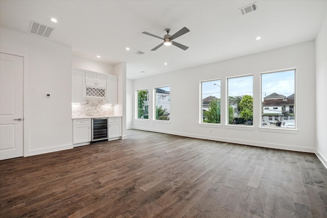 1609 Roy St, Houston, TX 77007 - unfurnished living room featuring beverage cooler, bar, dark wood-style floors, ceiling fan, and recessed lighting