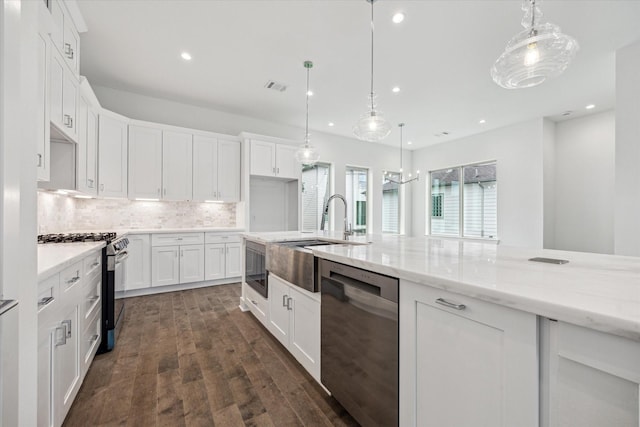1609 Roy St, Houston, TX 77007 - kitchen with stainless steel appliances, recessed lighting, tasteful backsplash, white cabinets, and light stone counters