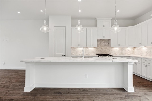 1609 Roy St, Houston, TX 77007 - kitchen with an island with sink, decorative backsplash, white cabinetry, and recessed lighting