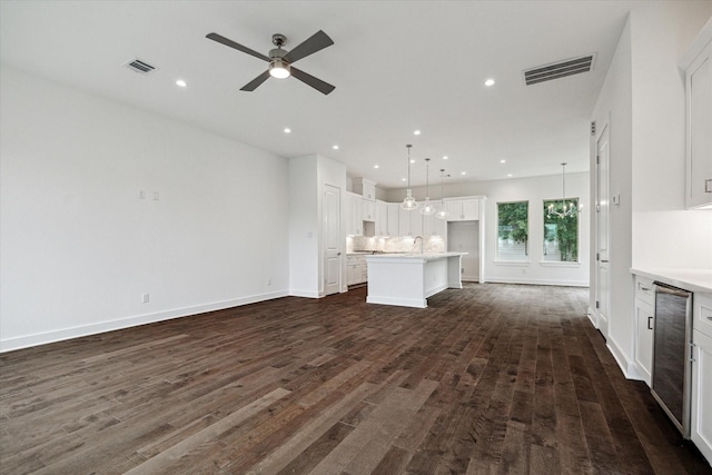 1609 Roy St, Houston, TX 77007 - unfurnished living room with ceiling fan, dark wood-style floors, wine cooler, and recessed lighting