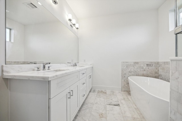 1609 Roy St, Houston, TX 77007 - bathroom with a freestanding tub, marble finish floors, and double vanity