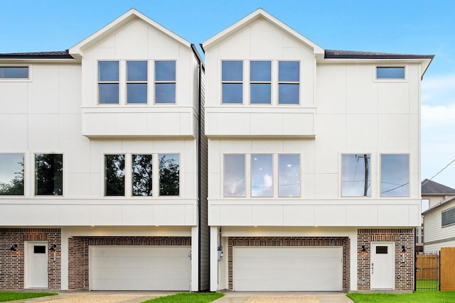 1609 Roy St, Houston, TX 77007 - view of front of property with brick siding, a garage, driveway, and stucco siding