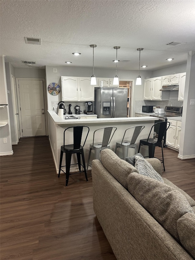 2379 Briarwest Blvd Unit 12, Houston, TX 77077 - living room featuring a textured ceiling, dark wood finished floors, and recessed lighting