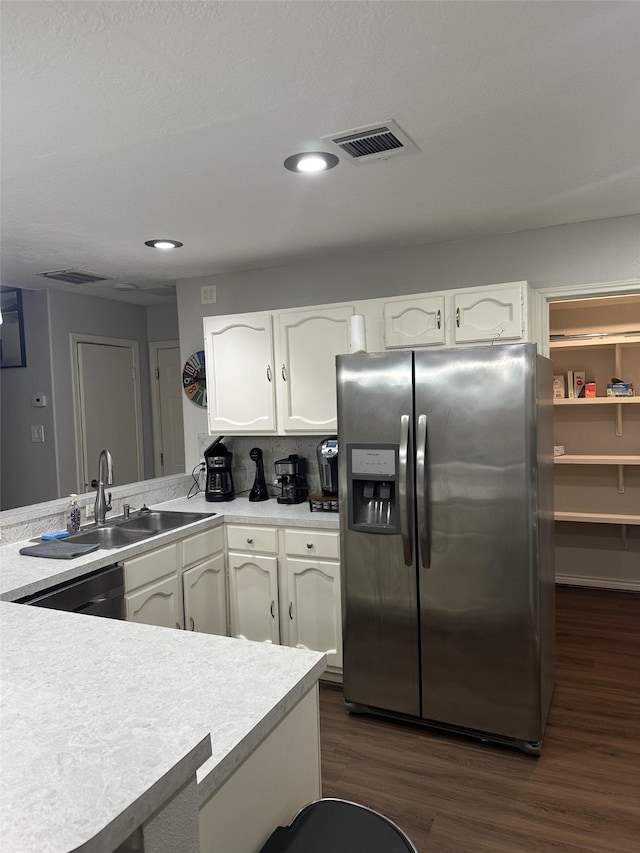 2379 Briarwest Blvd Unit 12, Houston, TX 77077 - kitchen with stainless steel fridge, white cabinetry, light countertops, and recessed lighting